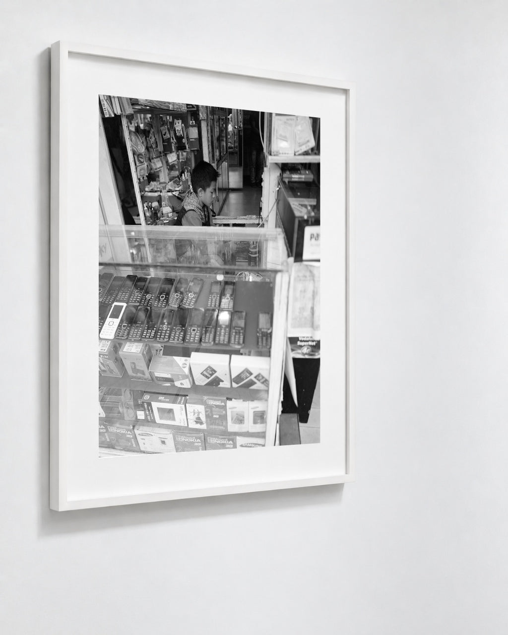 Cell Shop Boy, Shillong, India, 2017 — framed on wall