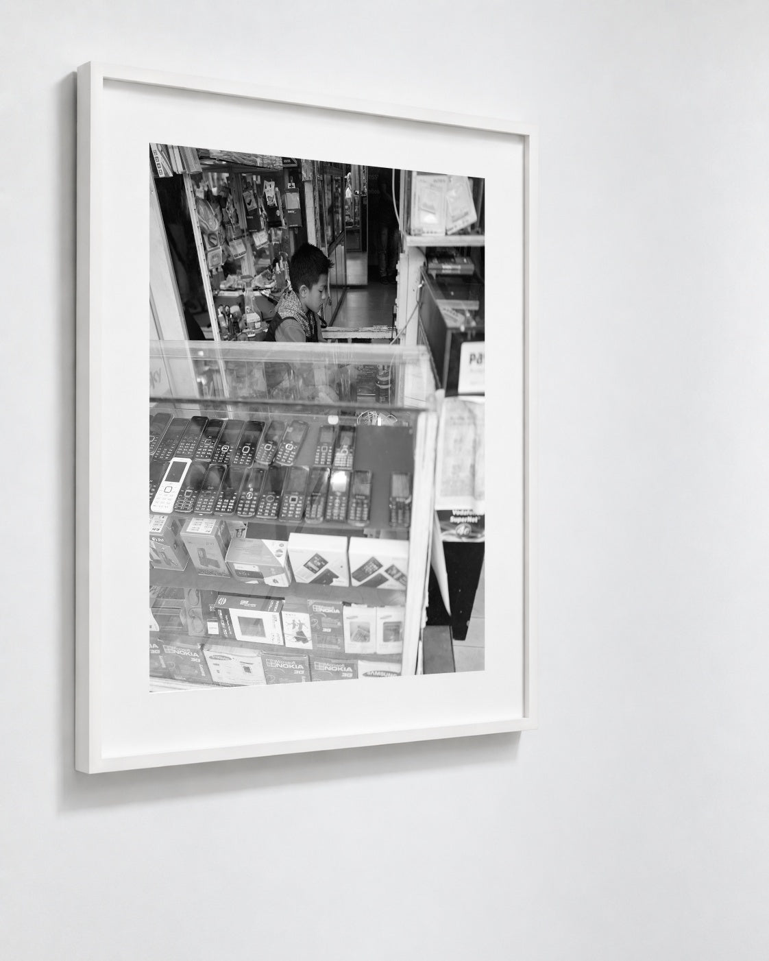 Cell Shop Boy, Shillong, India, 2017 — framed on wall